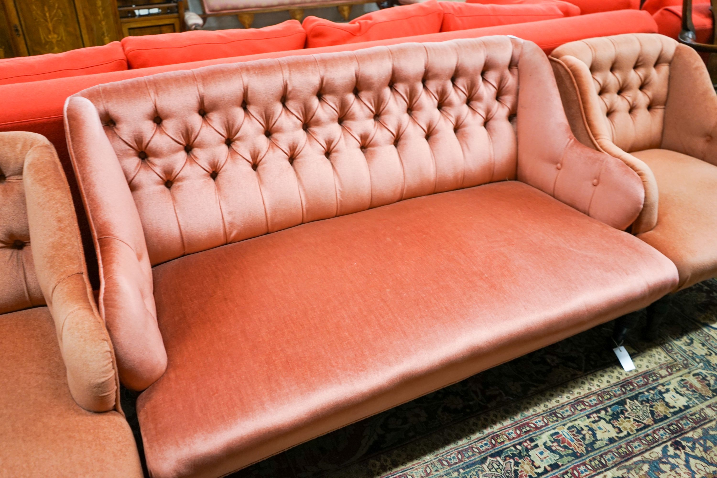 A late Victorian three piece lounge suite, upholstered in pink dralon, settee length 140cm, depth 80cm, height 78cm